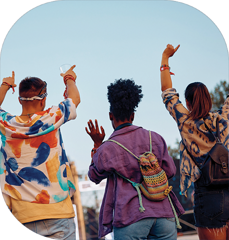 3 friends with their hands in the air