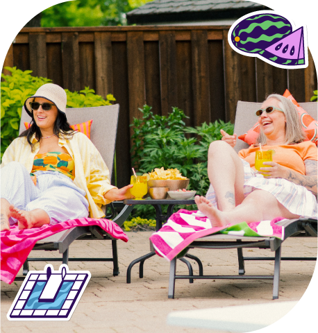 Two women lounging poolside